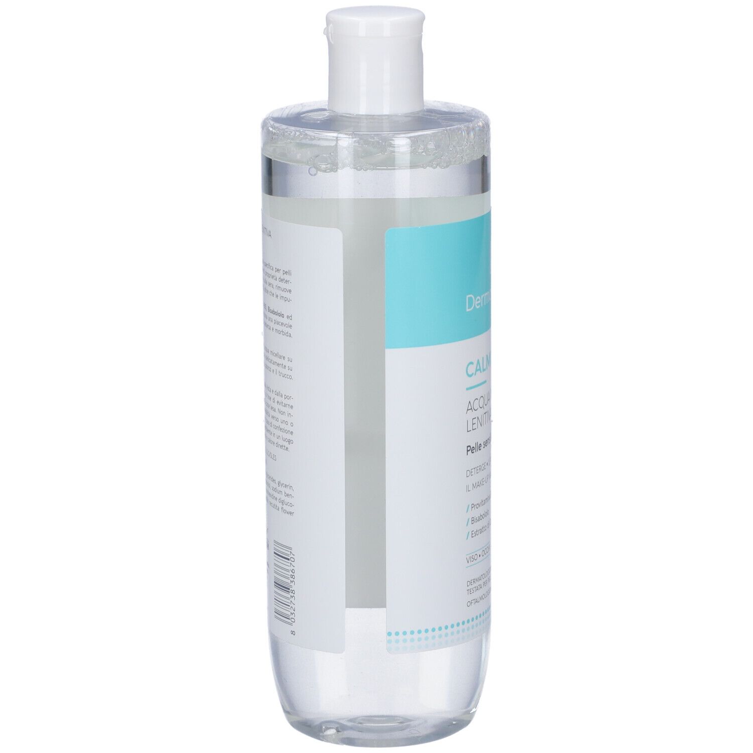 Flacone cilindrico, vista laterale. Tappo bianco. Etichetta con testo. Liquido trasparente. Imballaggio parzialmente trasparente.