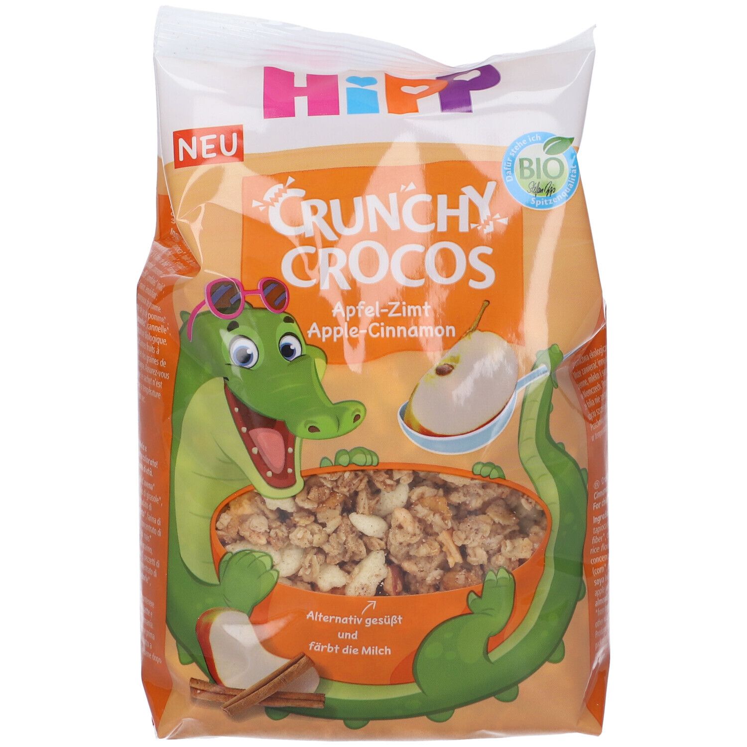 Confezione di Hipp Crunchy Crocos Mela & Cannella. Illustrazione di un coccodrillo con occhiali. Sigillo biologico. Scritta: Crunchy Crocos Mela-Cannella.