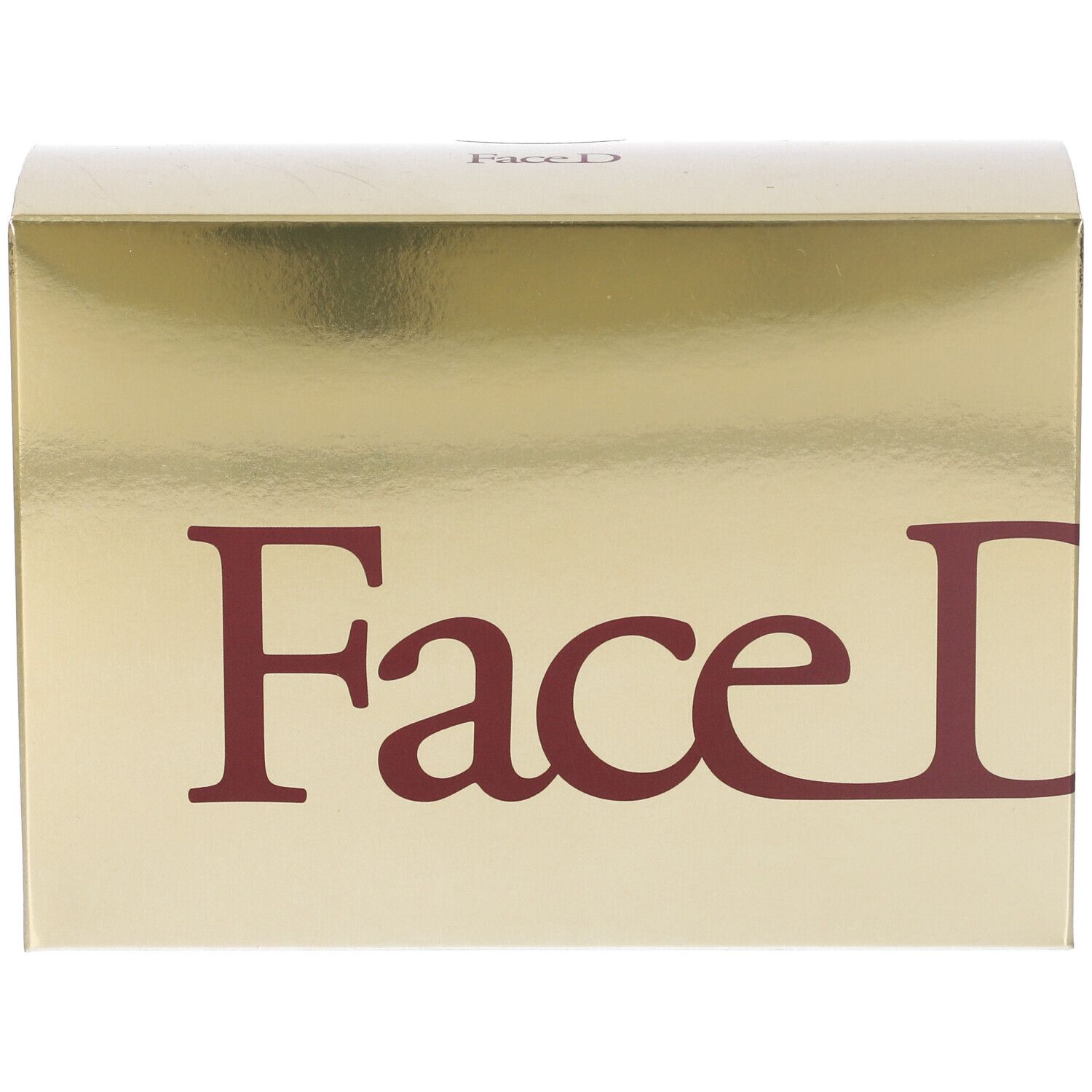 Scatola dorata con scritta rossa Face D. Superficie lucida. Confezione del prodotto.