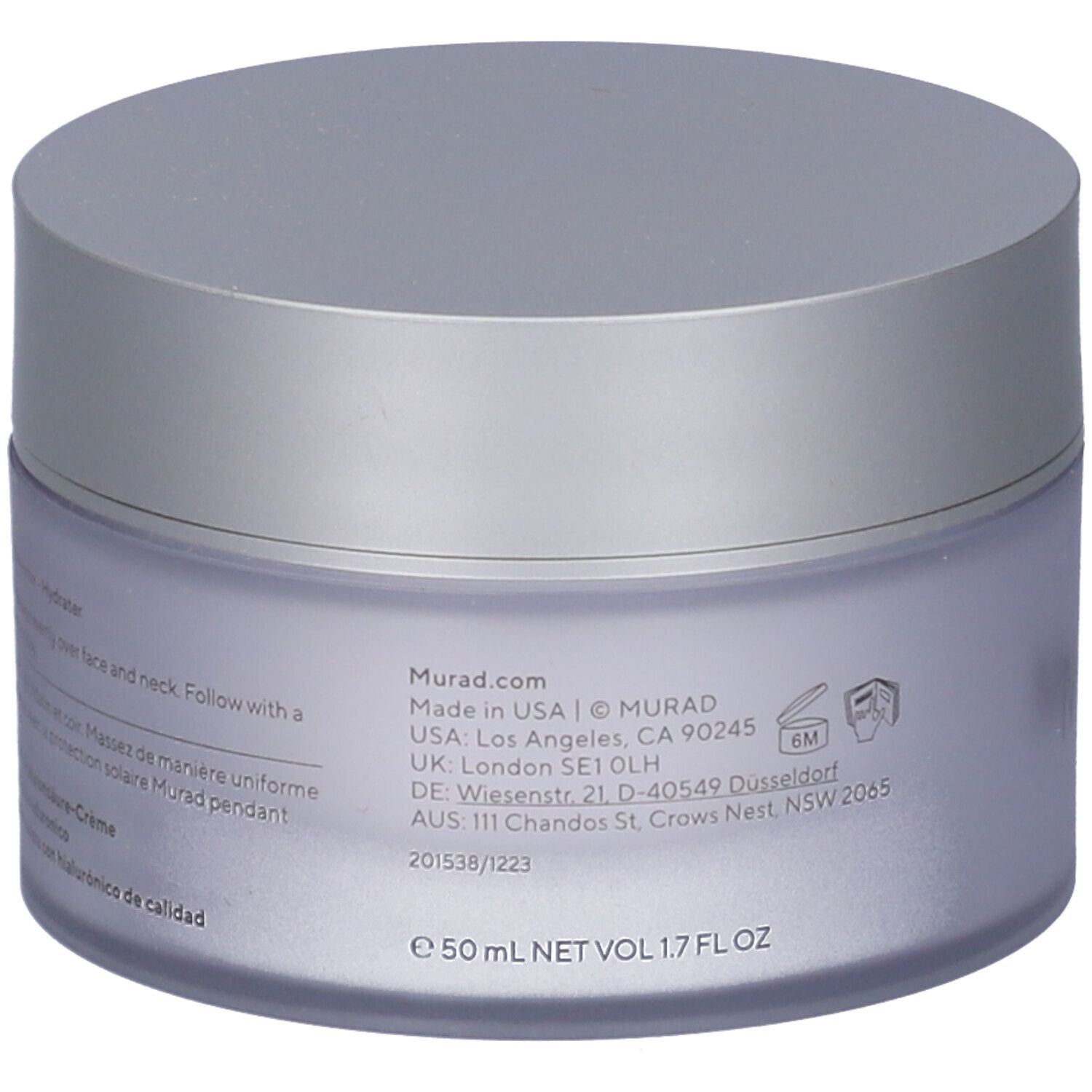 Vaso di crema con coperchio argentato. L'etichetta riporta "Murad" e informazioni sull'uso.