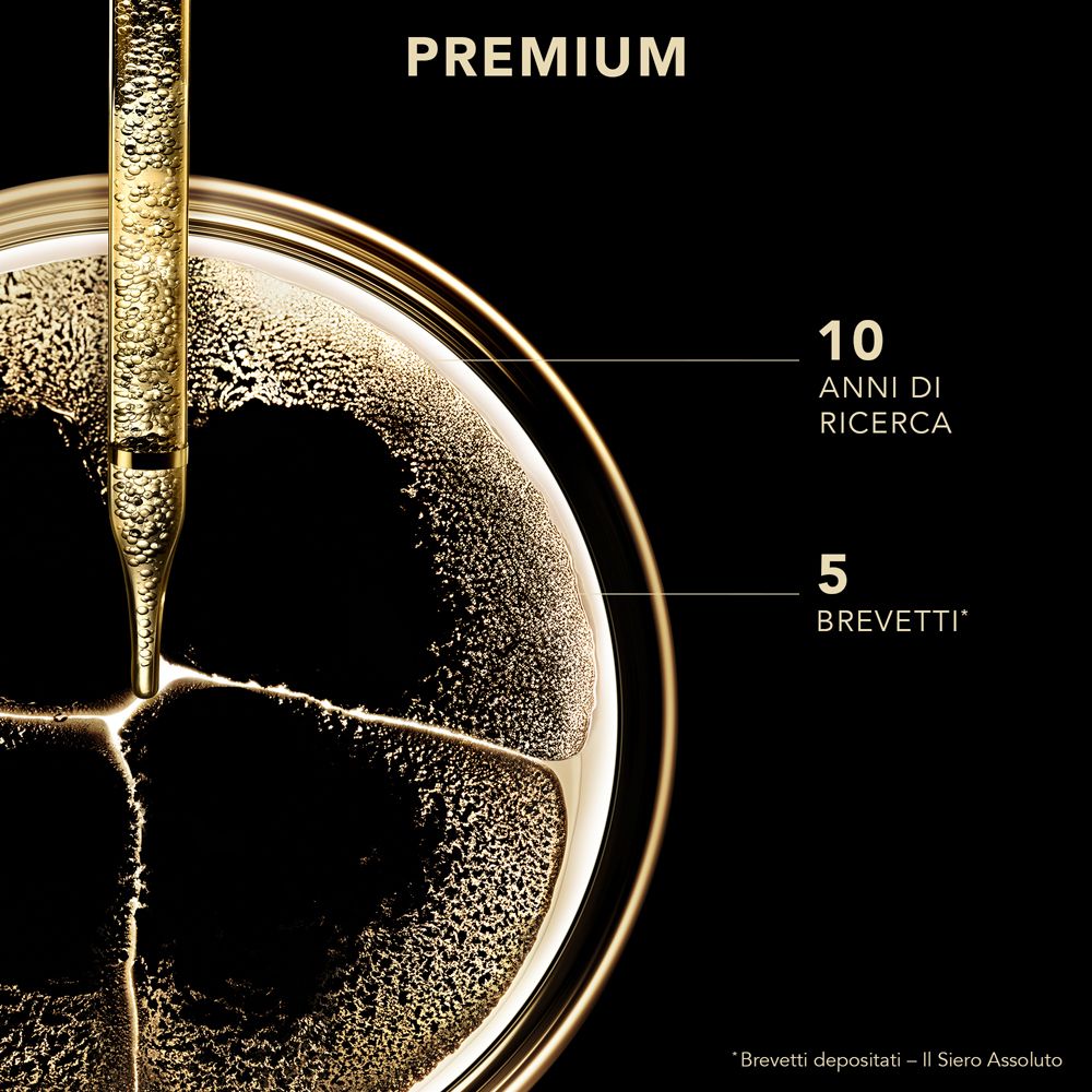 Pipetta dorata. Testo: Premium, 10 anni di ricerca, 5 brevetti.