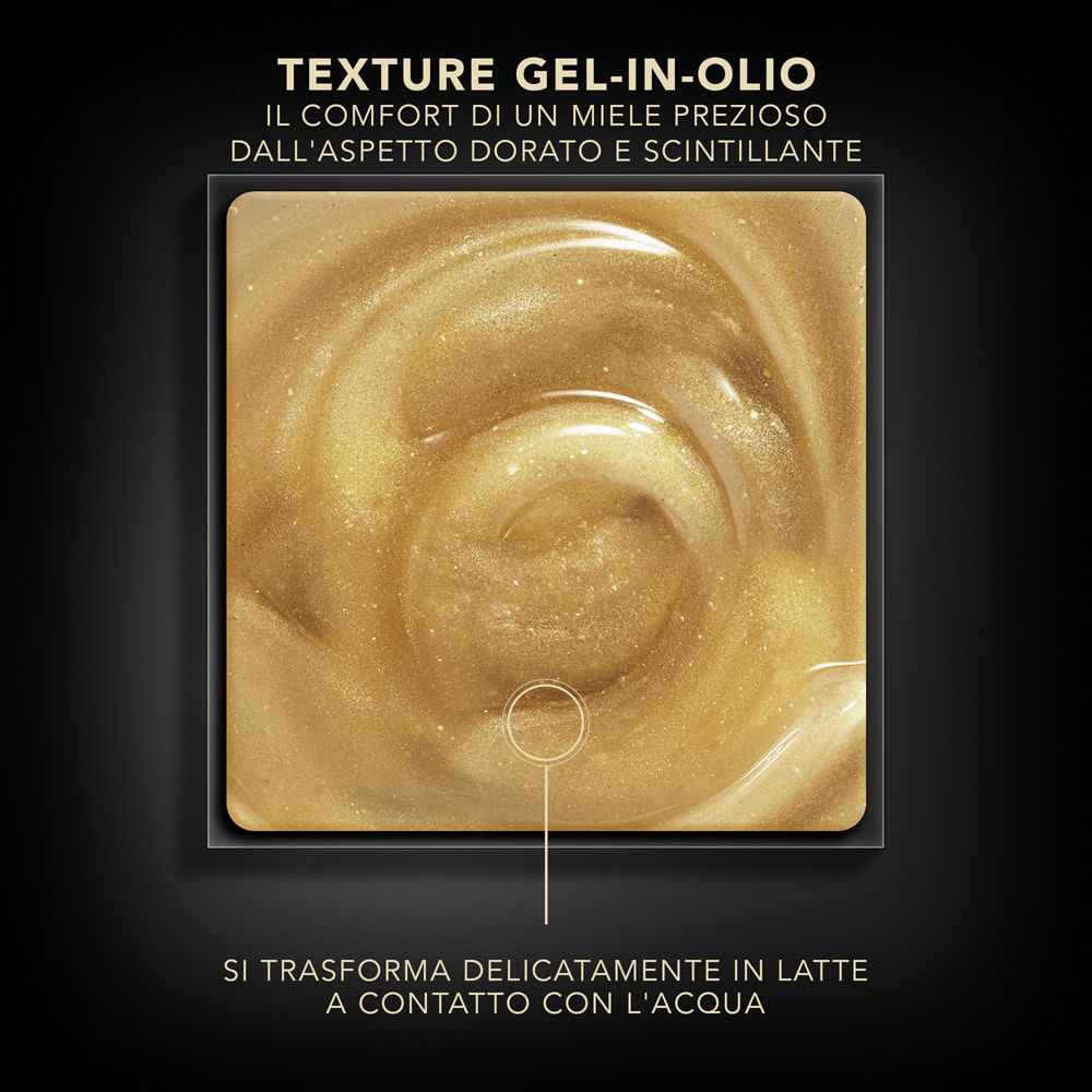 Primo piano di una texture gel-in-olio dorata. Testo: Si trasforma delicatamente in latte a contatto con l'acqua.