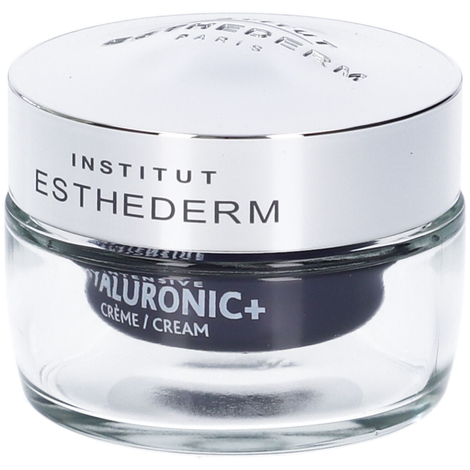 Vasetto di vetro con coperchio argentato. Scritta: INSTITUT ESTHEDERM. HYALURONIC+ CRÈME / CREAM. Sfondo nero.