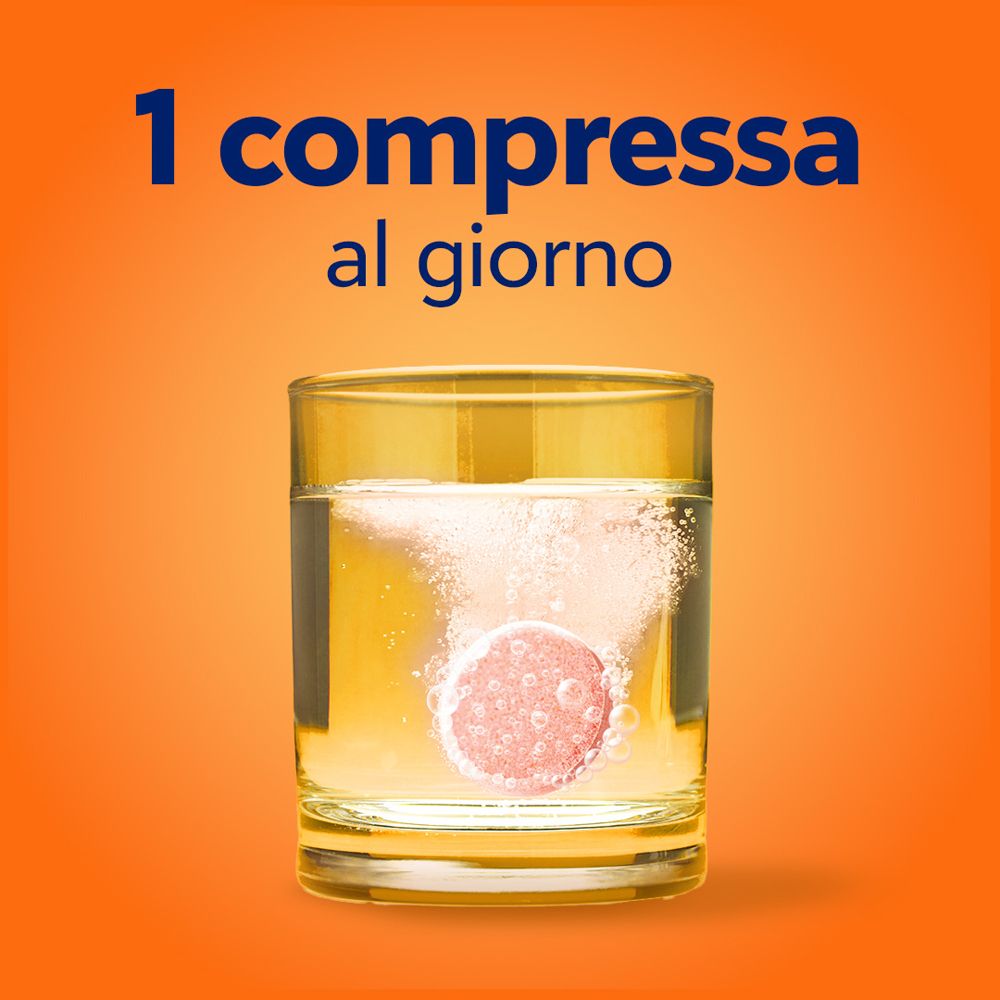 Bicchiere d'acqua con una compressa effervescente che si scioglie. Testo: 1 compressa al giorno.