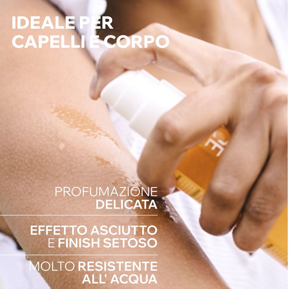 Applicazione dell'olio Uriage Bariesun su pelle e capelli.