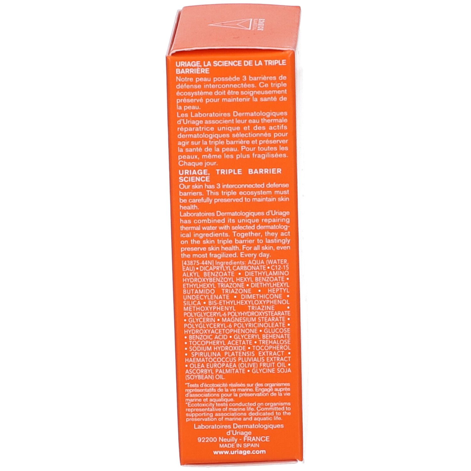 Lato della confezione del prodotto. Testo su Uriage, la tripla barriera e gli ingredienti. Prodotto in Spagna.