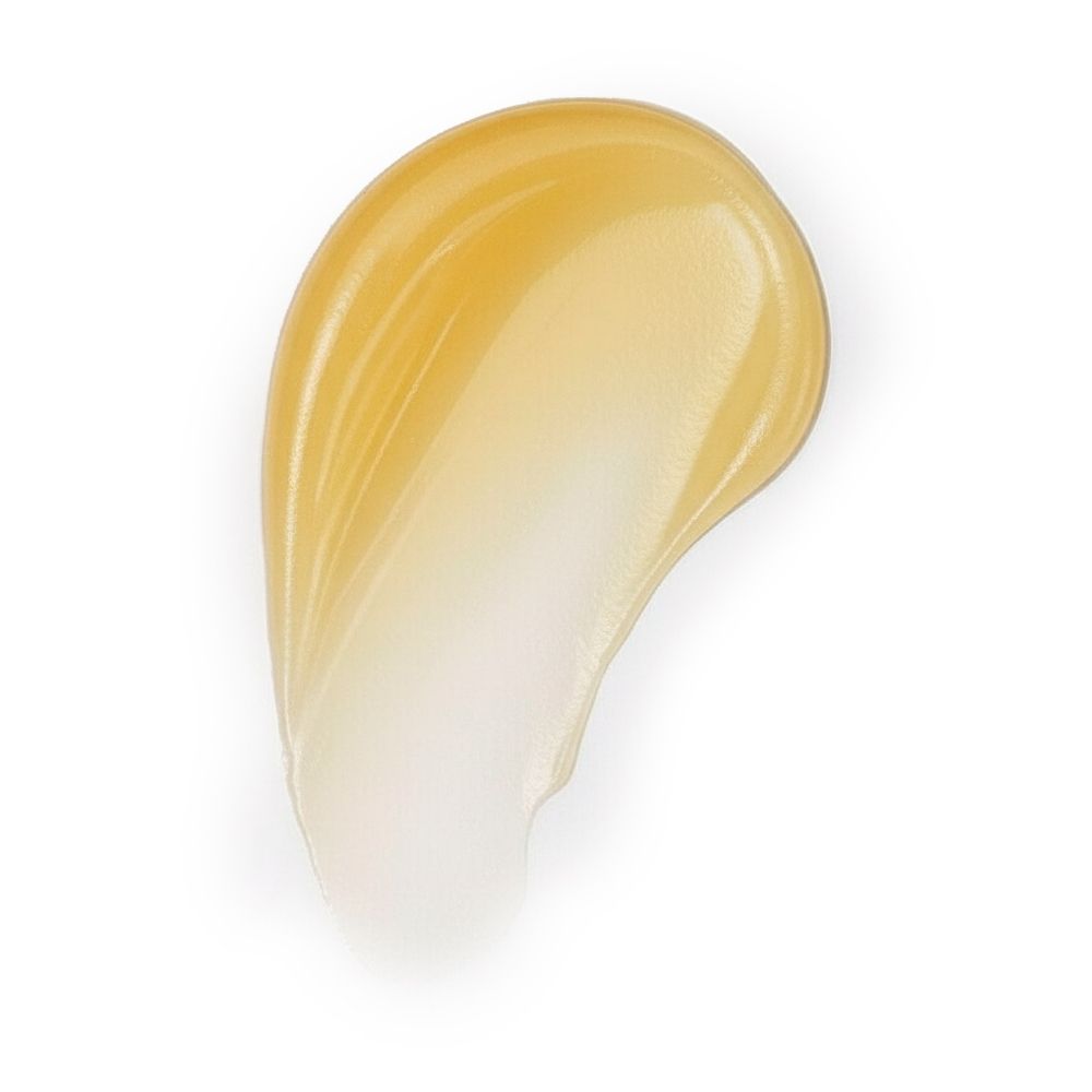 Traccia di balsamo giallo spalmata su sfondo bianco. Texture lucida.