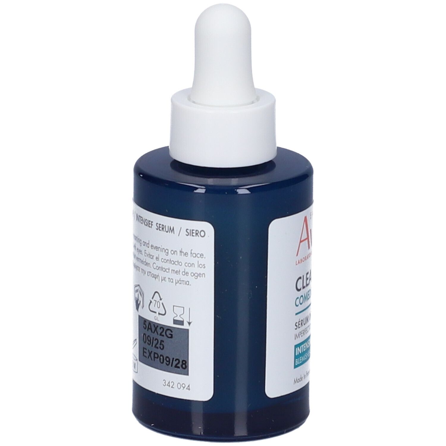 Flacone blu scuro con applicatore bianco. Retro con testo e simboli. Scadenza: 09/25, EXP09/28.