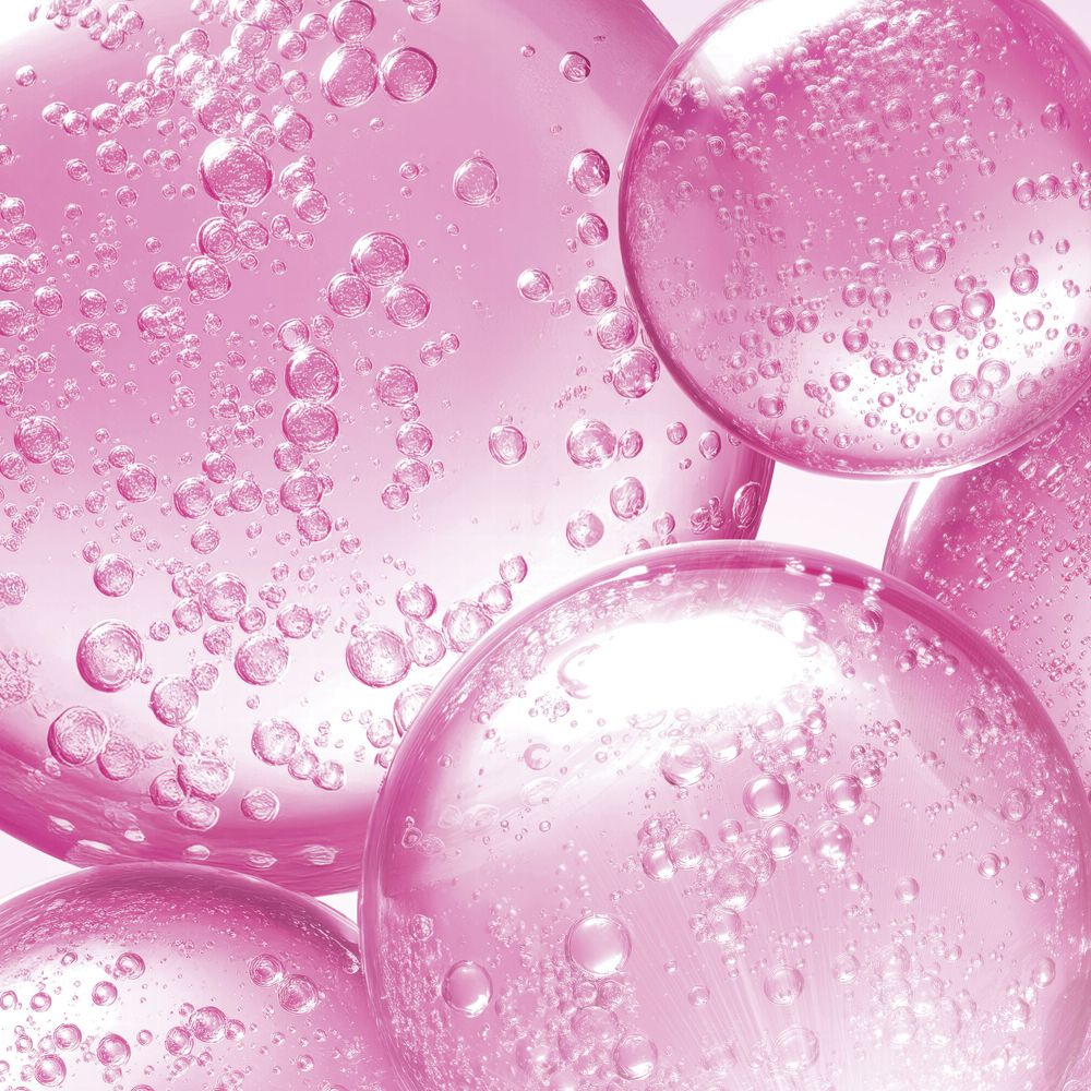 Primo piano di bolle rosa di diverse dimensioni. Alcune bolle hanno piccole bolle all'interno.