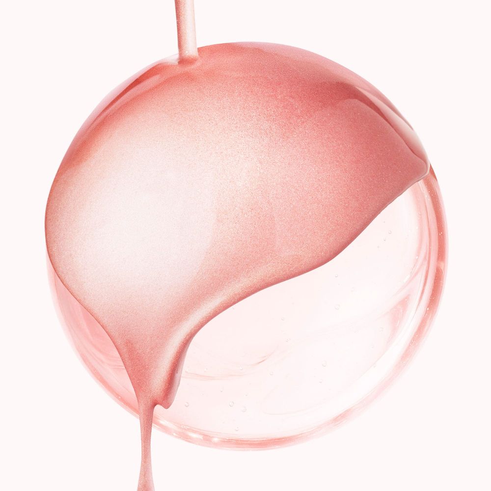 Liquido rosa che cola da una sfera. Texture brillante. Sfondo chiaro.
