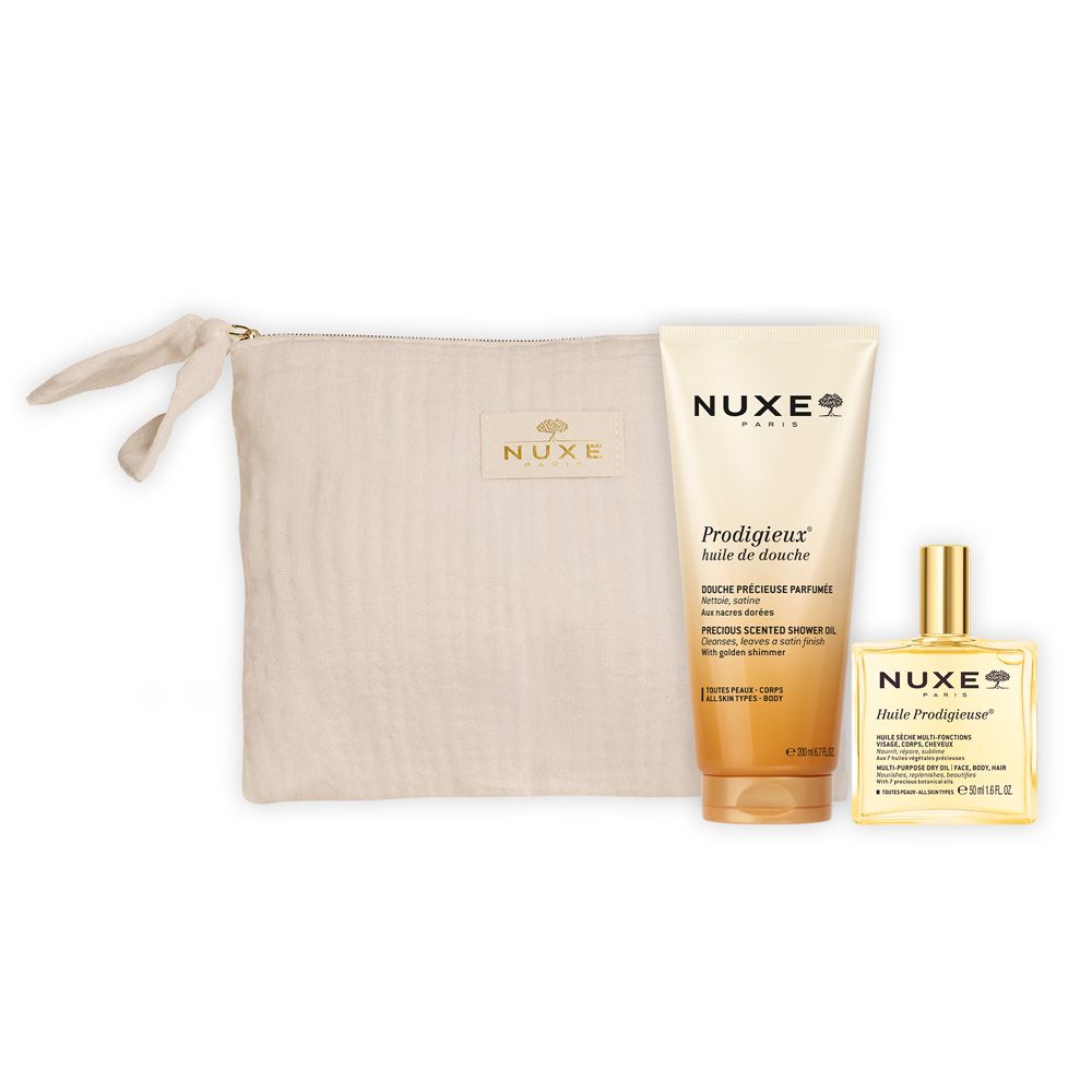 Pochette beige con prodotti Nuxe. Contiene gel doccia e olio. Logo Nuxe visibile.