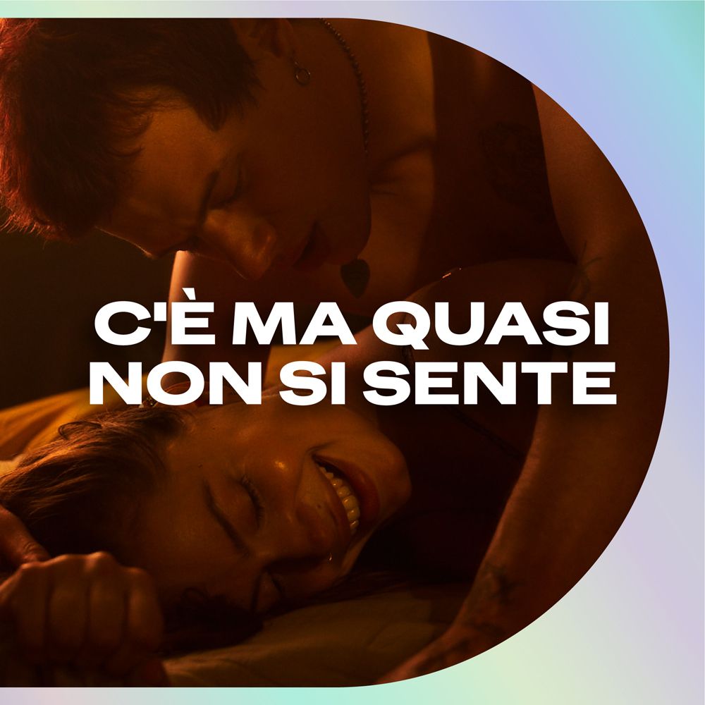 Primo piano di due persone che si baciano. Testo: C'è ma quasi non si sente.