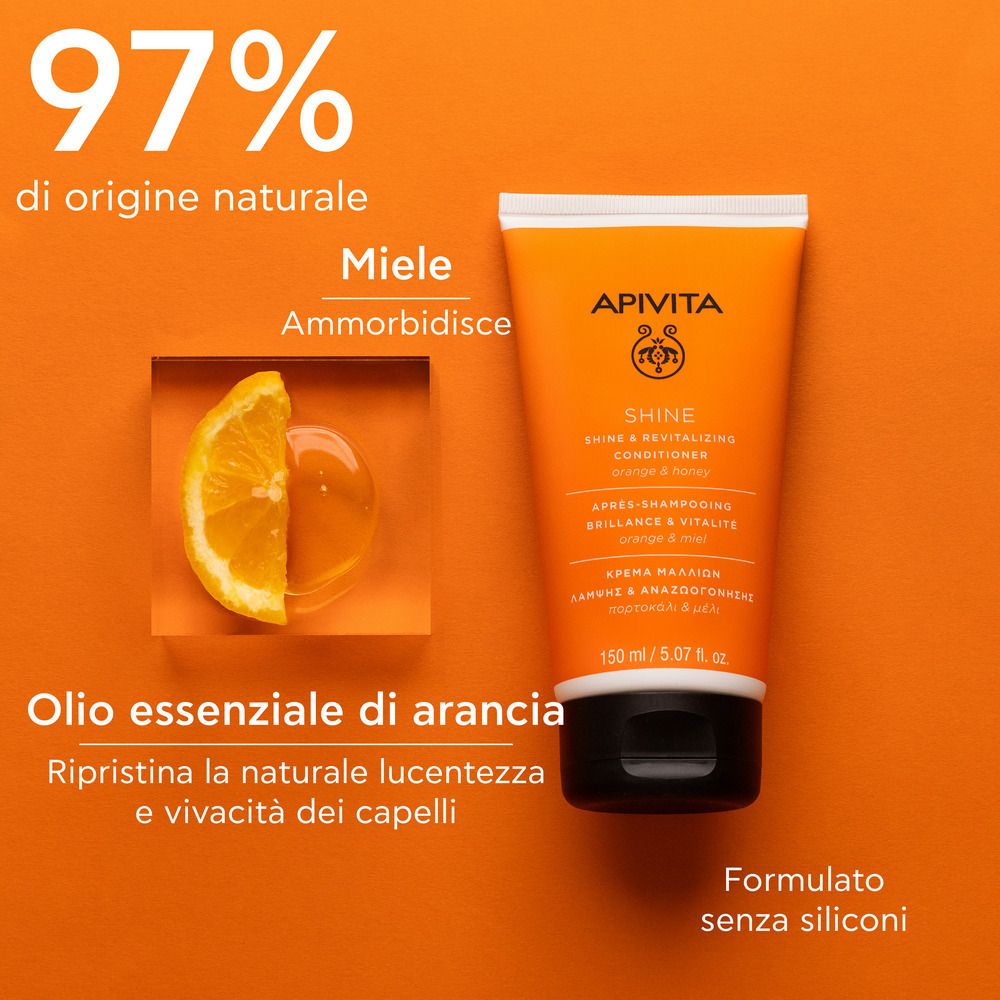 Tubo arancione con tappo bianco. Scritta: APIVITA SHINE Revitalisierender Conditioner. Testo: 97% di origine naturale, Olio essenziale di arancia.