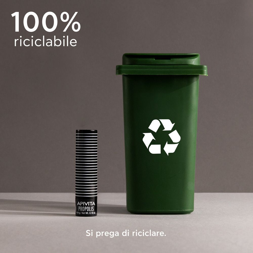 Stick per labbra accanto a un bidone verde con simbolo di riciclaggio. Testo: 100% riciclabile.