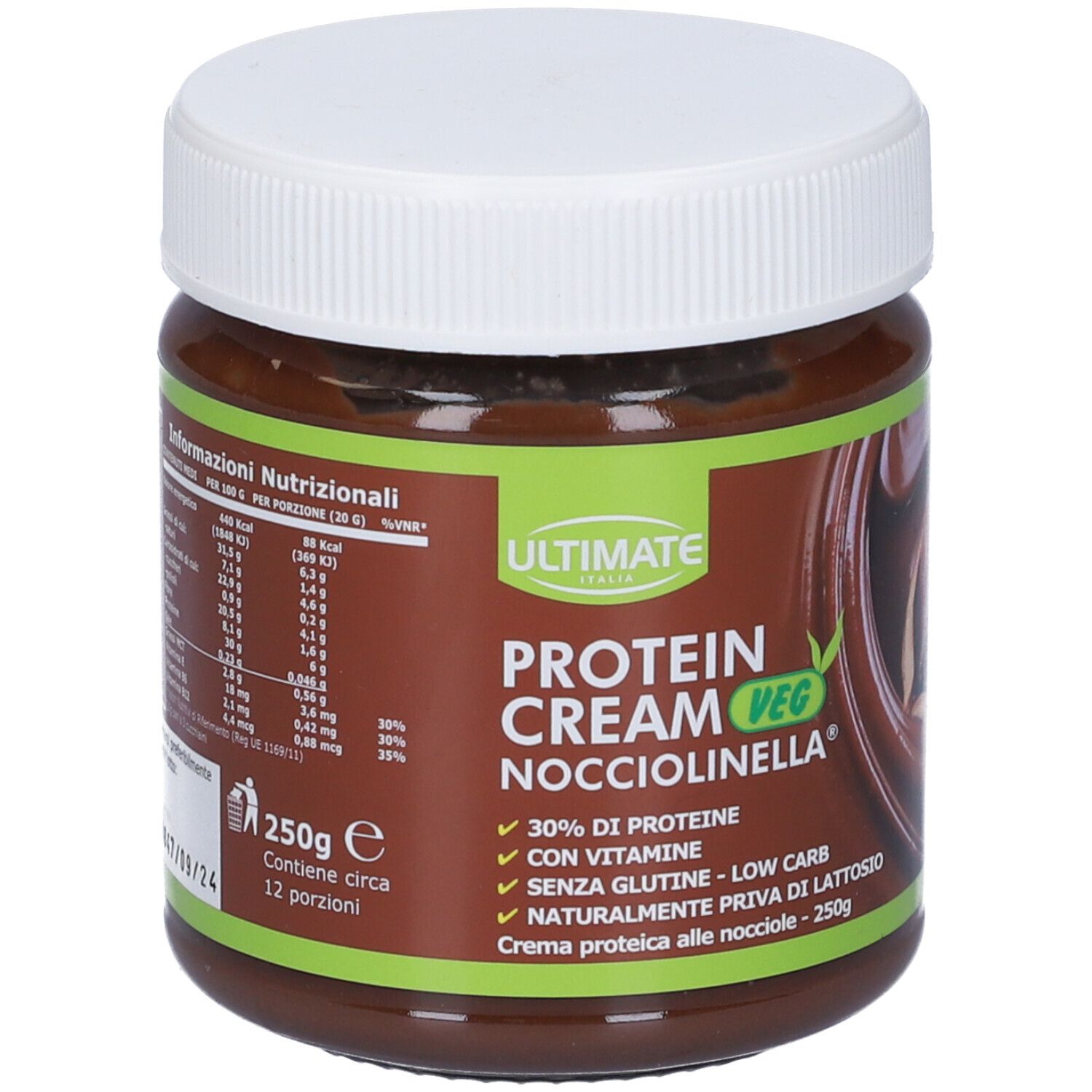 Barattolo marrone con coperchio bianco. Scritta: ULTIMATE Protein Cream Veg Nocciolinella. 250g, 12 porzioni. Etichetta verde-marrone.