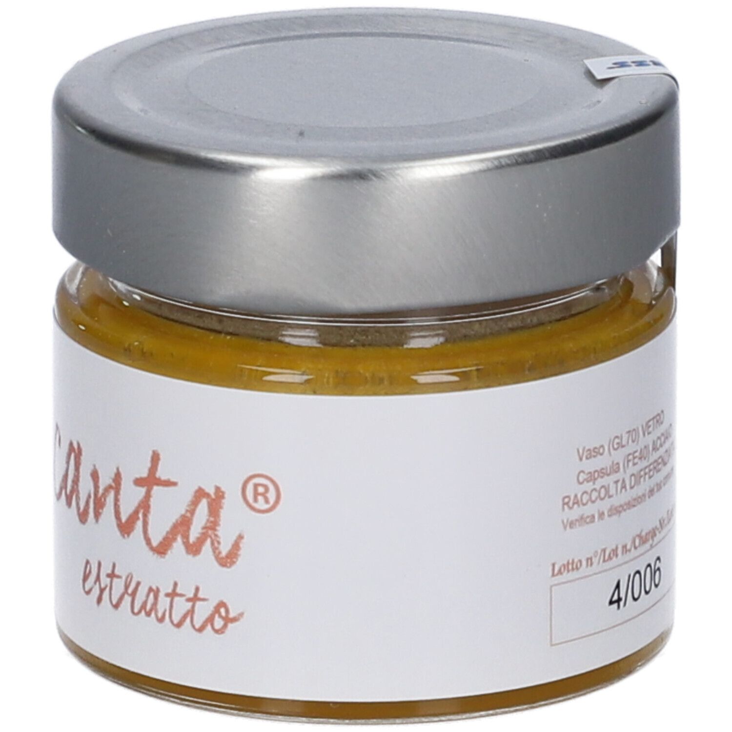 Vasetto di vetro con coperchio argentato. Scritta "Tropicanta estratto". Contenuto giallo visibile.
