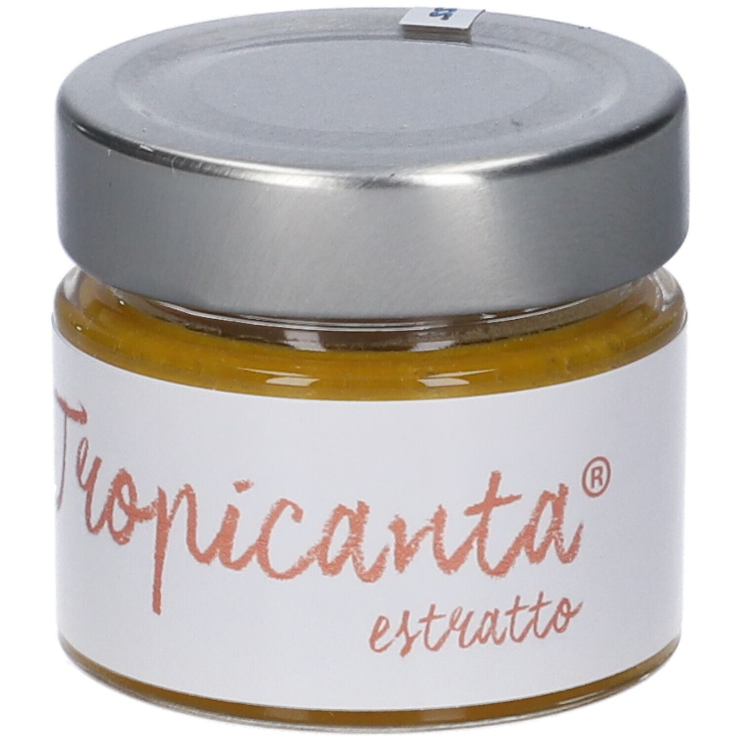 Vasetto di vetro con coperchio argentato. Scritta "Tropicanta estratto". Contenuto giallo visibile.