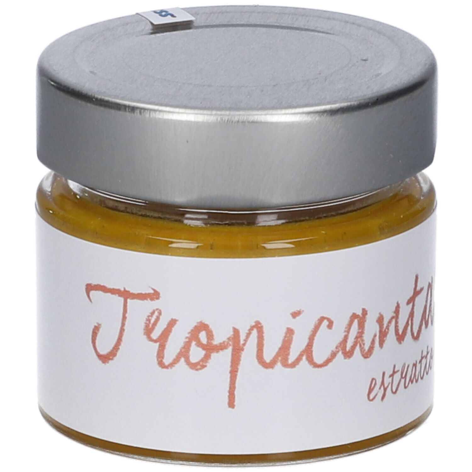 Vasetto di vetro con coperchio argentato. Scritta "Tropicanta estratto". Contenuto giallo visibile.