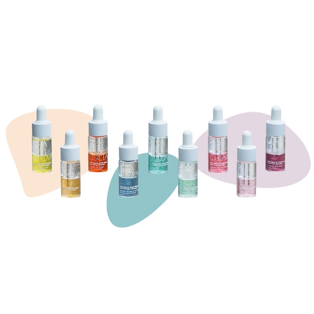 Otto piccole bottiglie con pipette. Diversi colori e liquidi. Etichettatura: Siero Concentrato, Crema Giorno, Crema Notte.