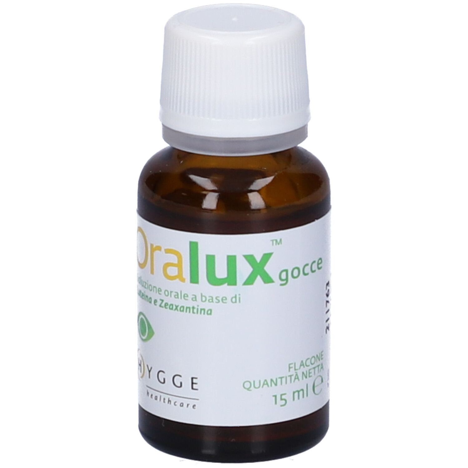 Flacone di vetro marrone con tappo bianco. Etichetta con informazioni sul prodotto. Marca: Oralux. 15 ml.