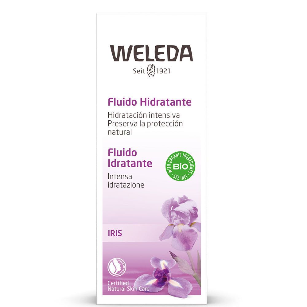 Confezione di fluido viso Weleda. Bianca, con accenti viola e fiori di iris. Testo: « Fludio Idratante » e sigillo « Bio ».