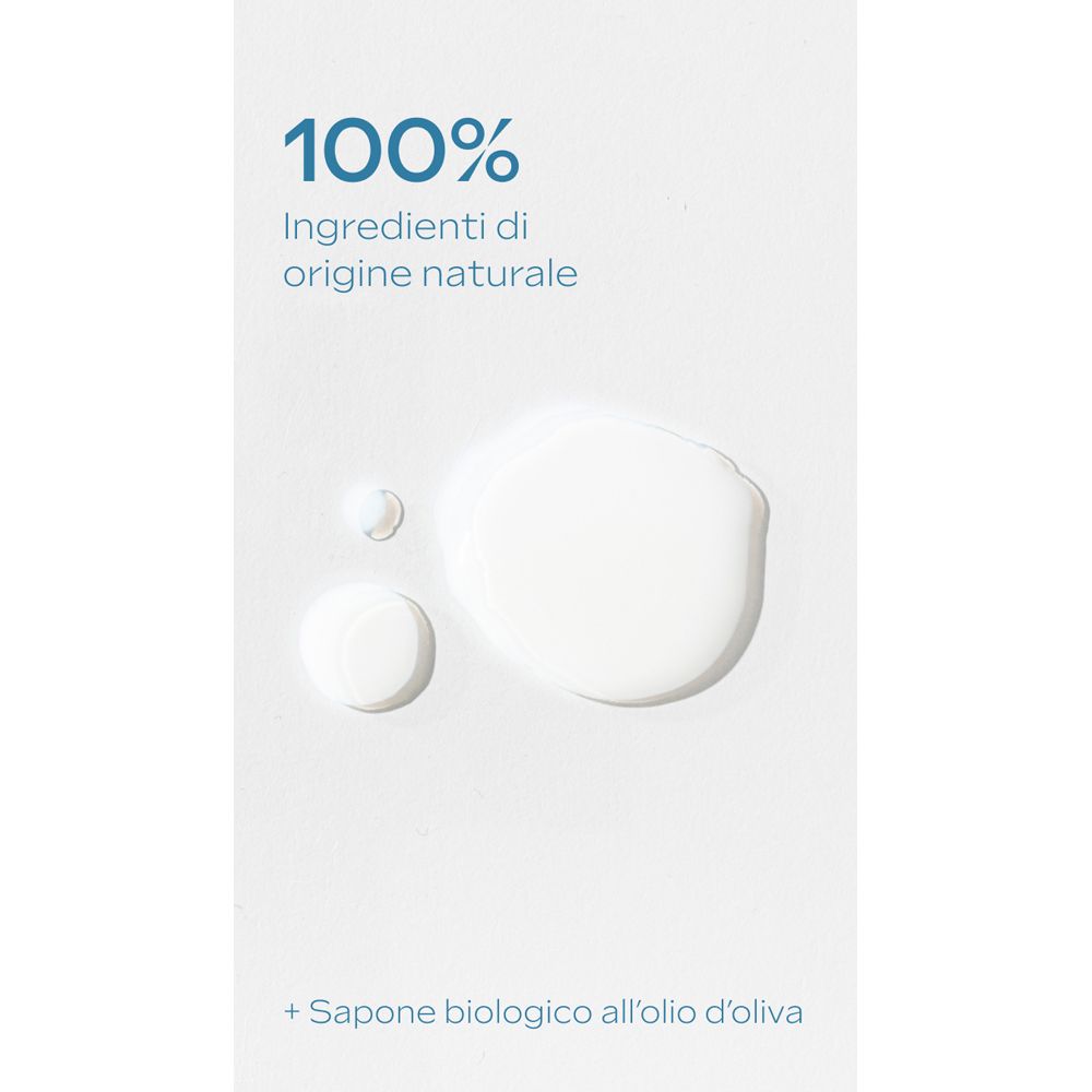 Superficie bianca con gocce. Testo: « 100% Ingredienti di origine naturale + Sapone biologico all'olio d'oliva ».