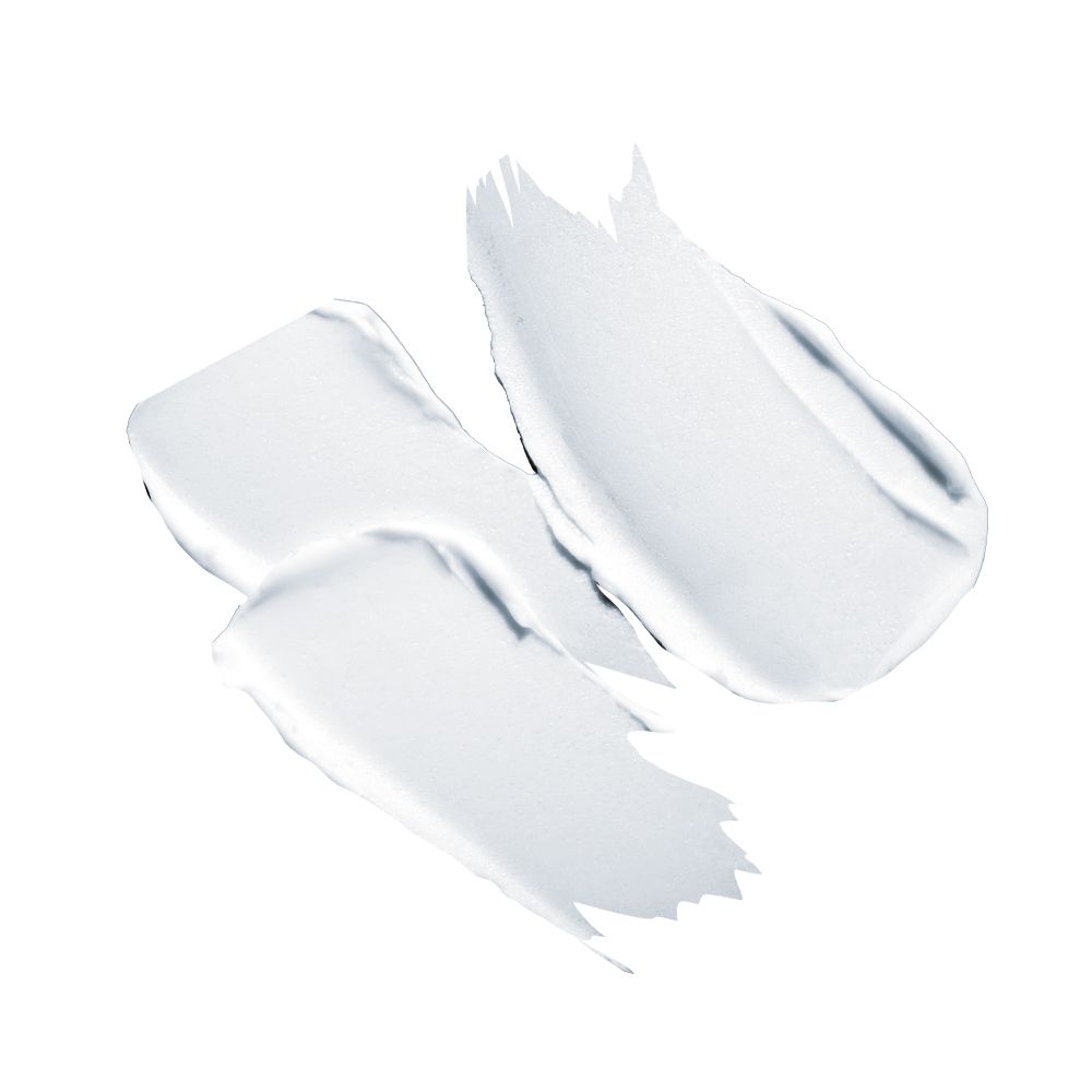 Tre strisce di crema bianca su sfondo bianco. Consistenza visibile.