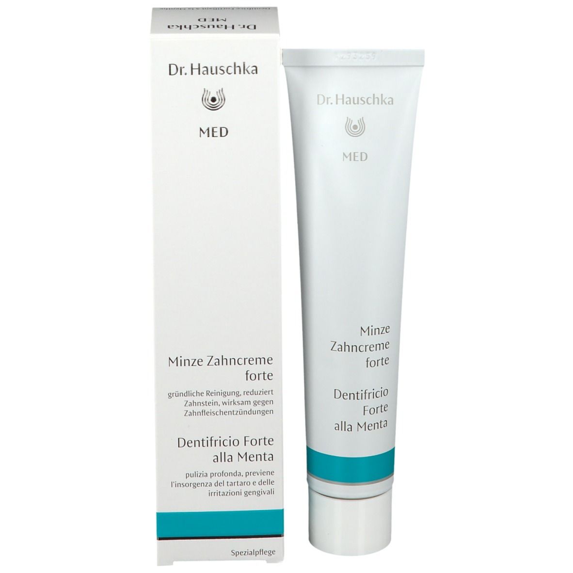 Tubo di dentifricio e scatola. Scritta: Dr. Hauschka MED, Minze Zahncreme forte, Dentifricio alla Menta. Confezione bianca.