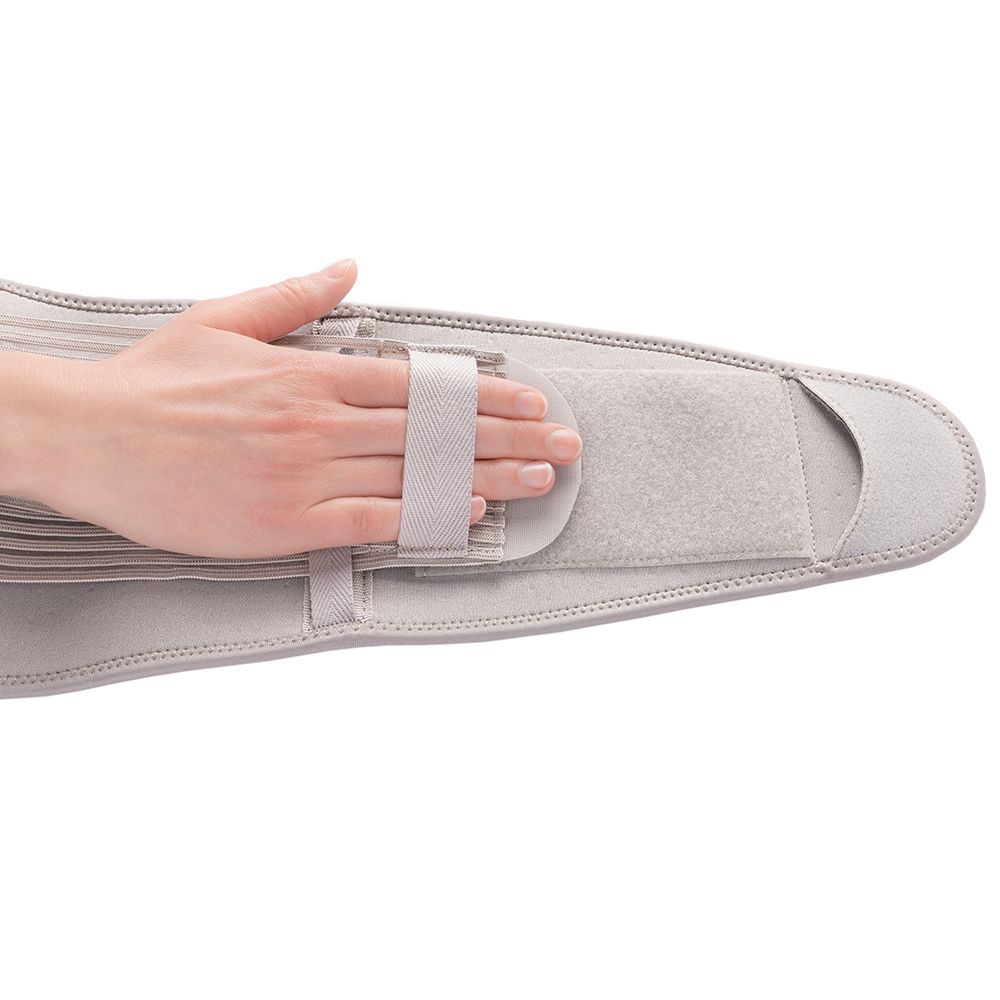 Actimove Everyday Supporto per Schiena. Mano sulla chiusura in velcro. Supporto lombare grigio.