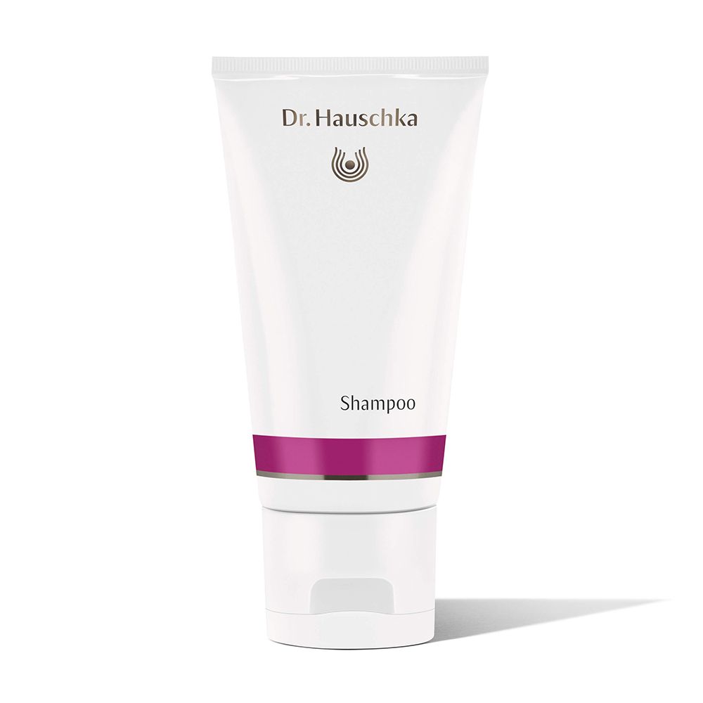Tubo bianco con fascia viola. Scritta: Dr. Hauschka, Shampoo. Tappo in basso.