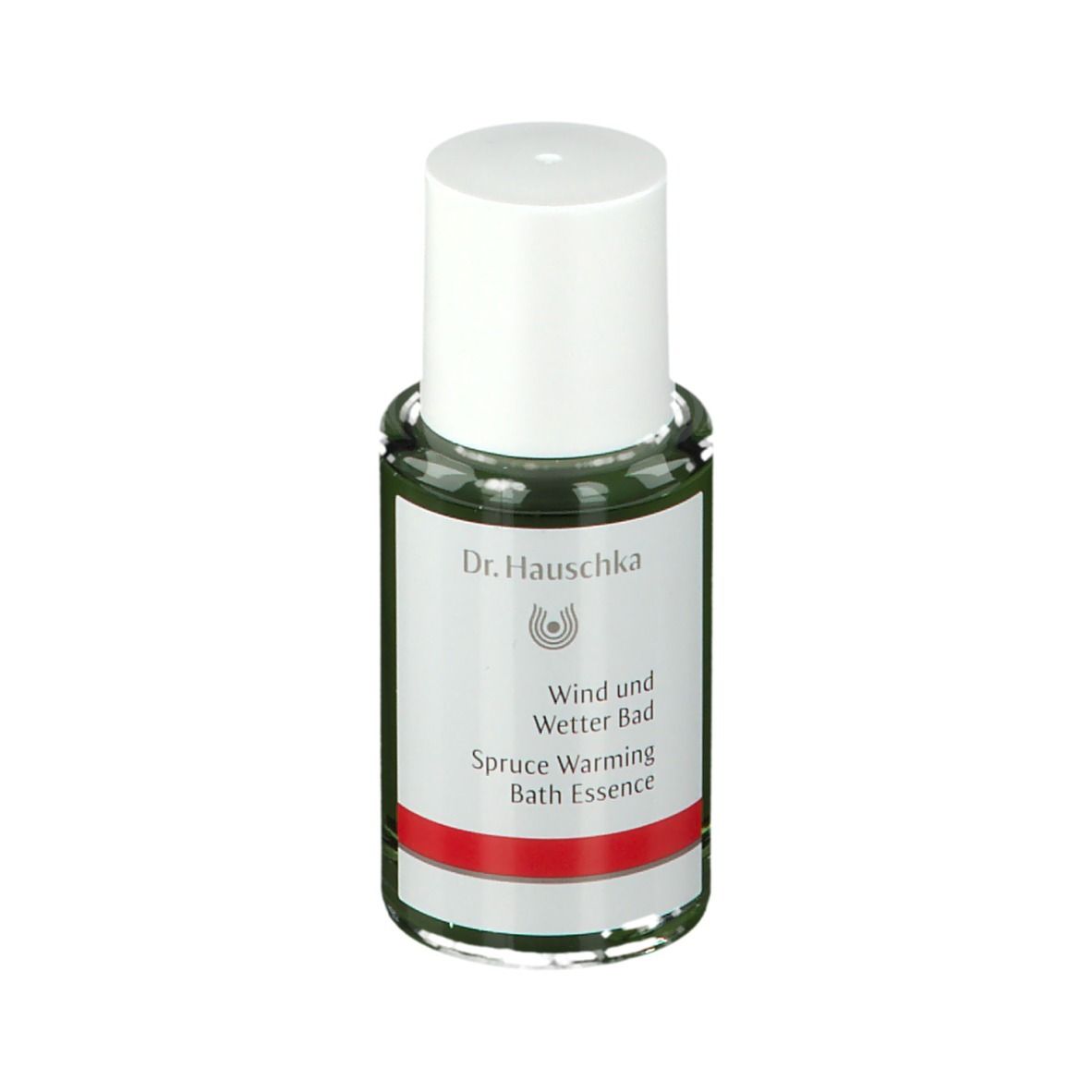Flacone di vetro verde con tappo bianco. Etichetta con logo Dr. Hauschka e testo: Wind und Wetter Bad, Spruce Warming Bath Essence.