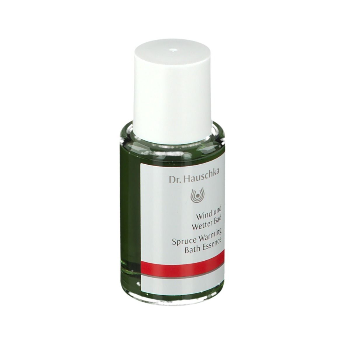 Flacone di vetro verde con tappo bianco. Etichetta con logo Dr. Hauschka e testo: Wind und Wetter Bad, Spruce Warming Bath Essence.
