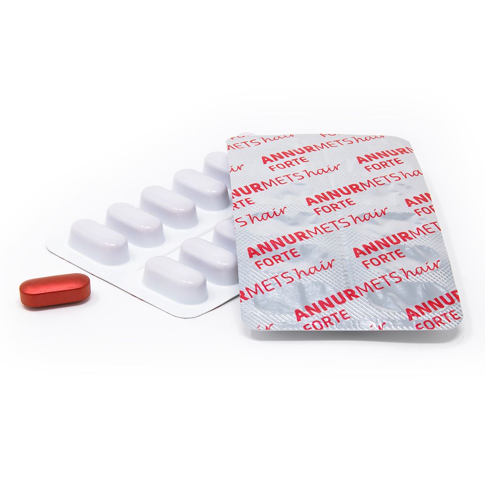 Una capsula rossa e un blister di compresse bianche. Il blister è stampato 'ANNURMETS hair FORTE'.