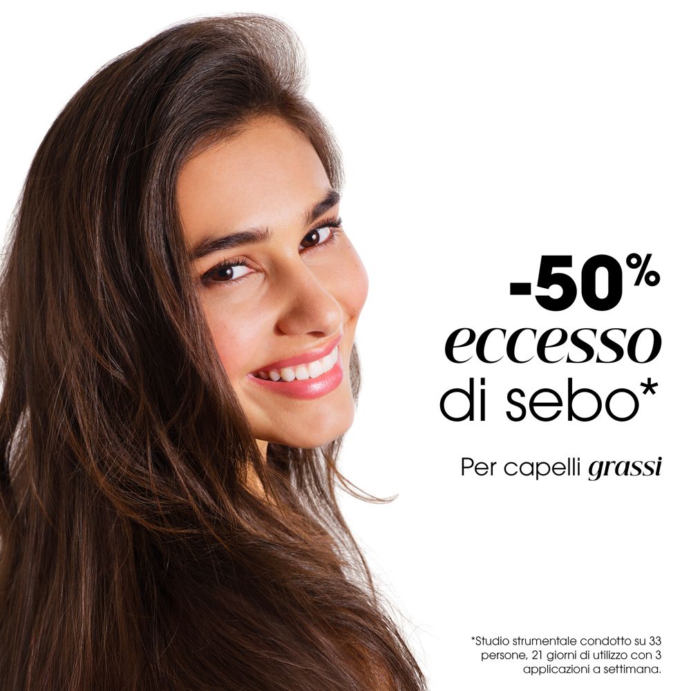 Donna con lunghi capelli castani. Testo: -50% eccesso di sebo. Per capelli grassi. Studio su 33 persone.