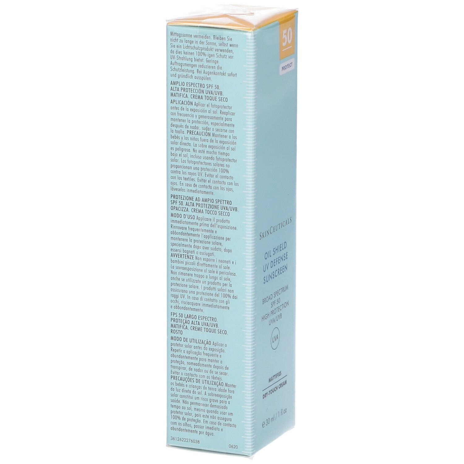 Confezione di cartone con testo. Scritta: Oil Shield UV Defense Sunscreen, SPF 50. Sfondo azzurro. Testo multilingue.