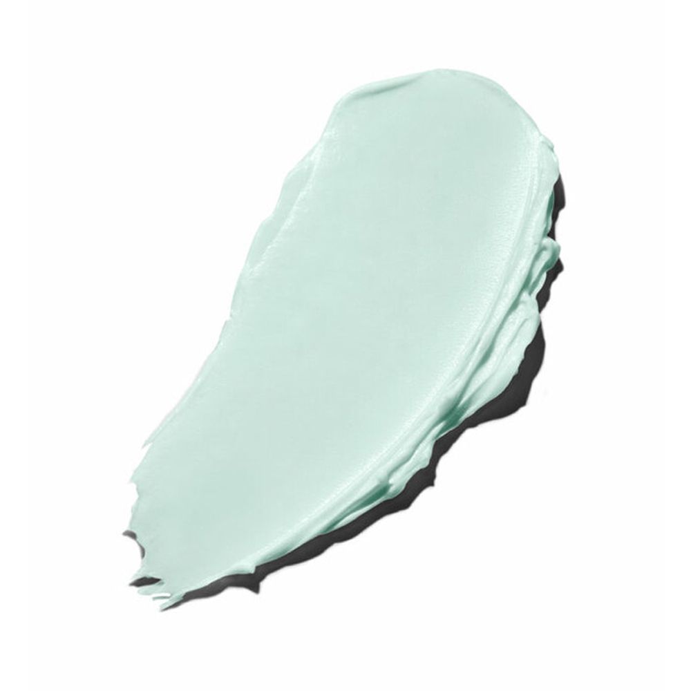 Crema verde chiaro su sfondo bianco. La crema è applicata con un motivo irregolare.