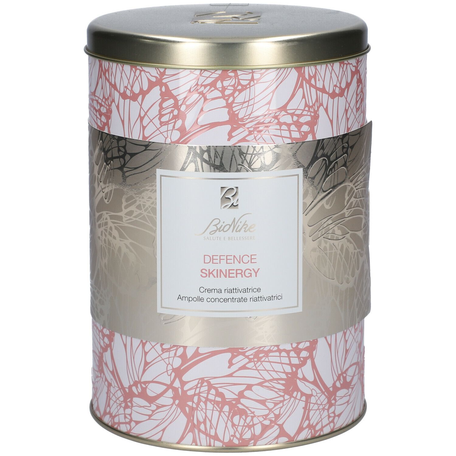 Barattolo cilindrico con motivo floreale e fascia argentata. La fascia riporta 'DEFENCE SKINERGY' e 'Crema riattivatrice'.