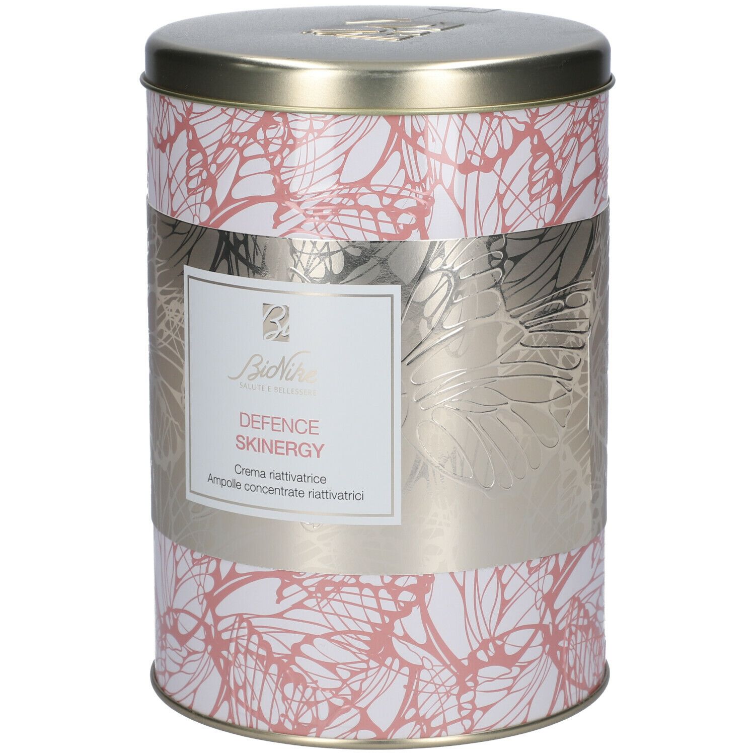 Barattolo cilindrico con motivo floreale e fascia argentata. La fascia riporta 'DEFENCE SKINERGY' e 'Crema riattivatrice'.