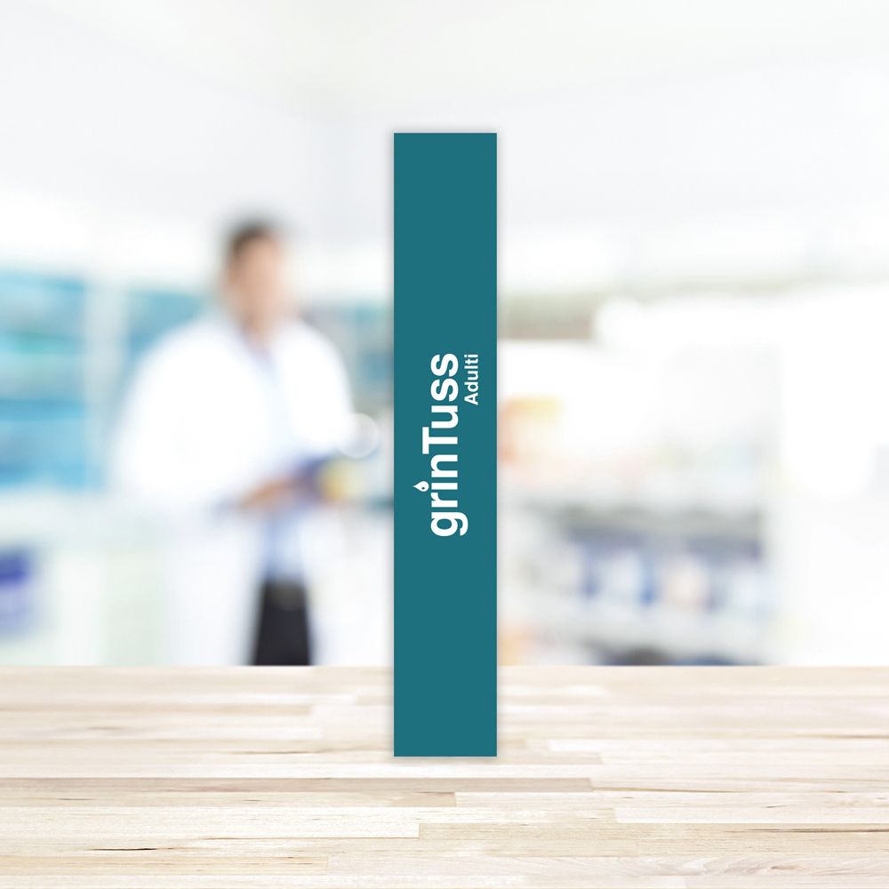 Scatola stretta verde Grintuss Adulti. Scritto: Grintuss Adulti. Vista verticale.