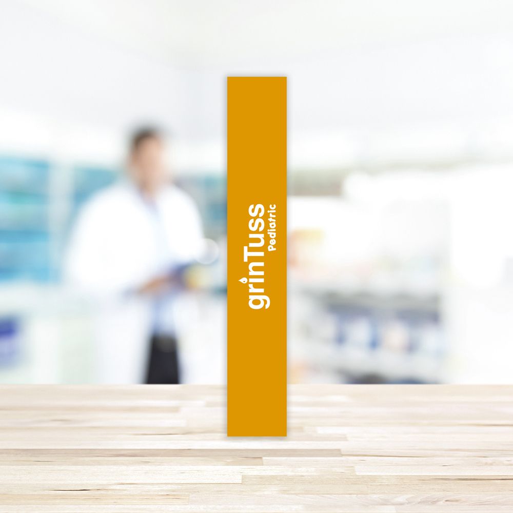 Lato stretto e giallo della confezione Grintuss Pediatric. Logo e nome del prodotto.