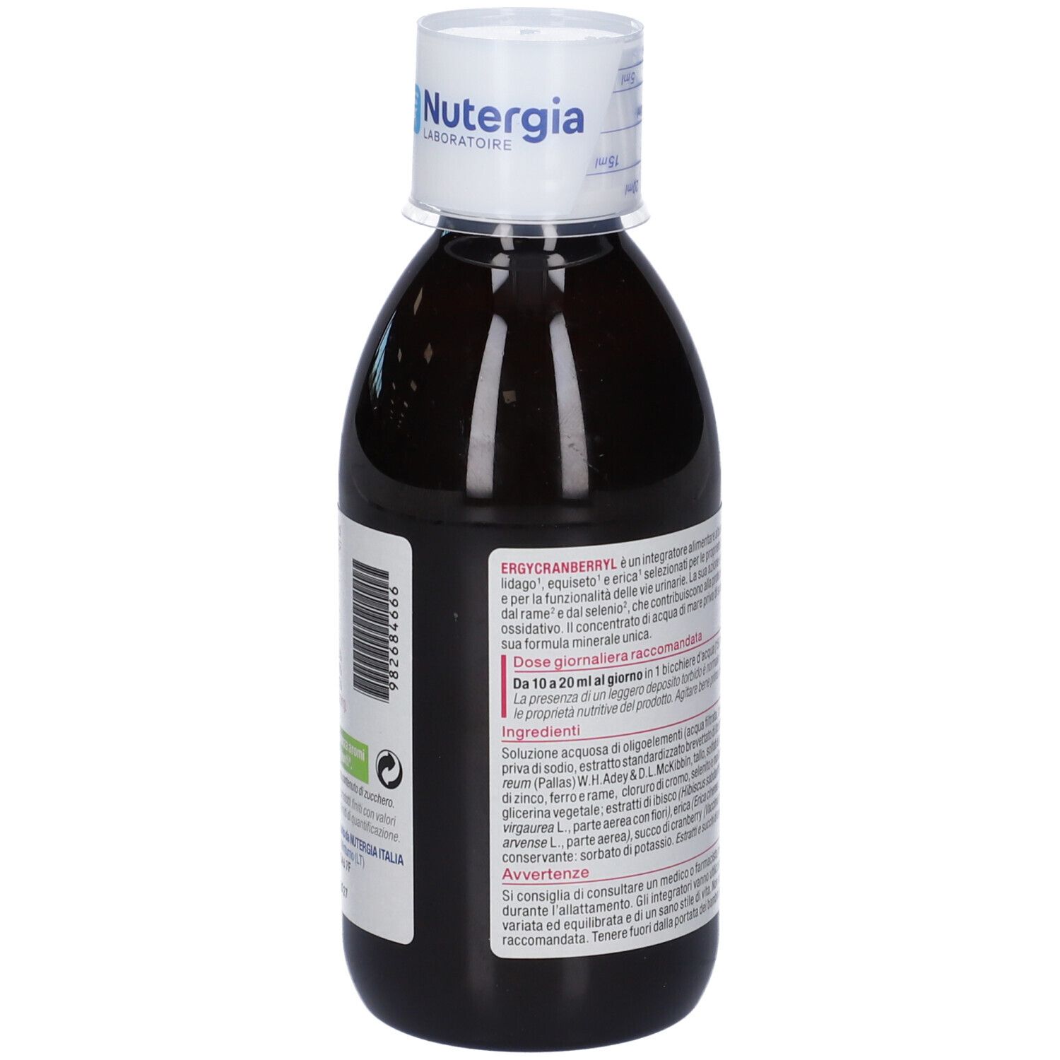 Vista posteriore di una bottiglia di liquido marrone. Etichetta con testo. Tappo bianco con logo.