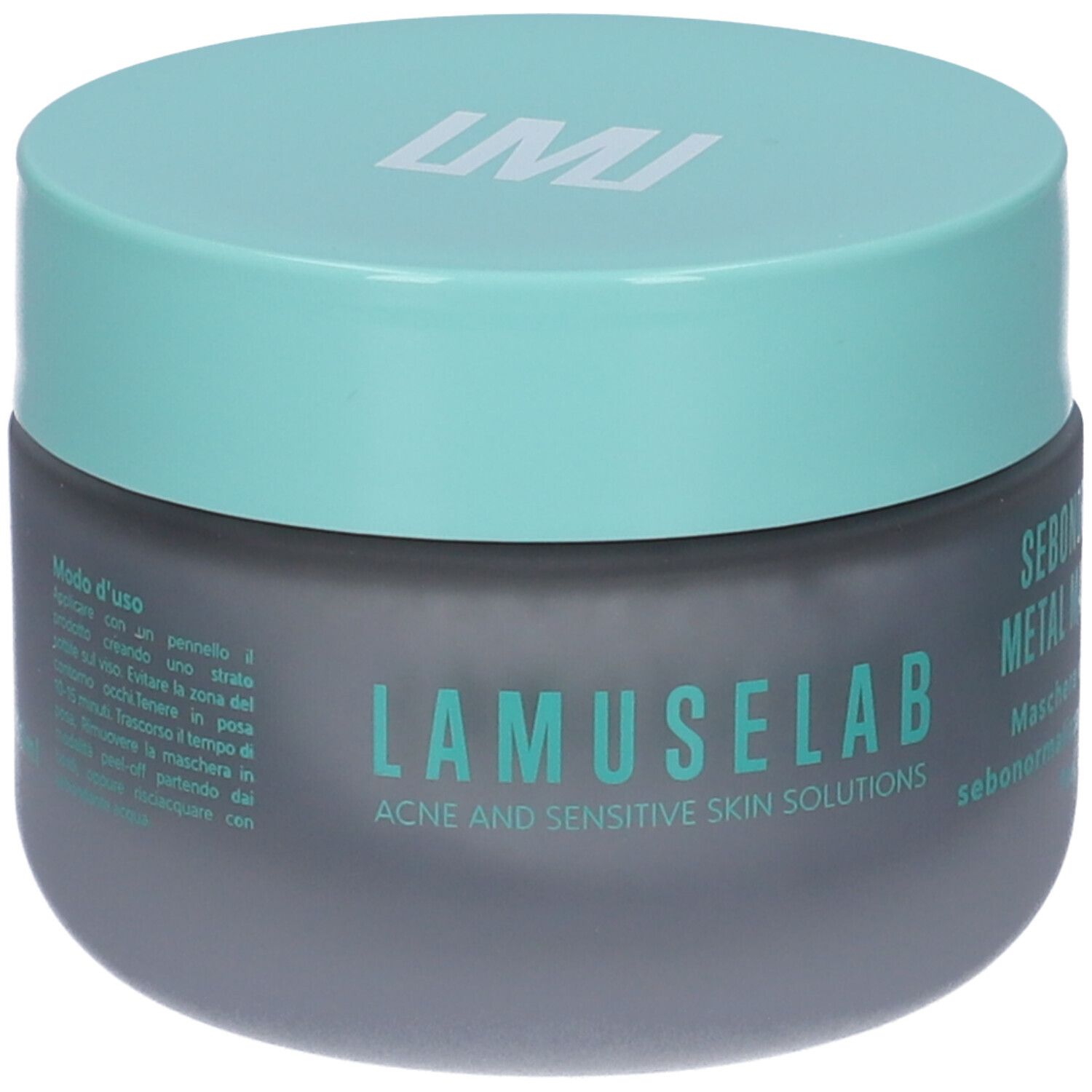 Vaso grigio scuro con coperchio turchese. Scritta LAMUSELAB. Testo: SEBONORM METAL MASK. Istruzioni per l'uso sul retro.