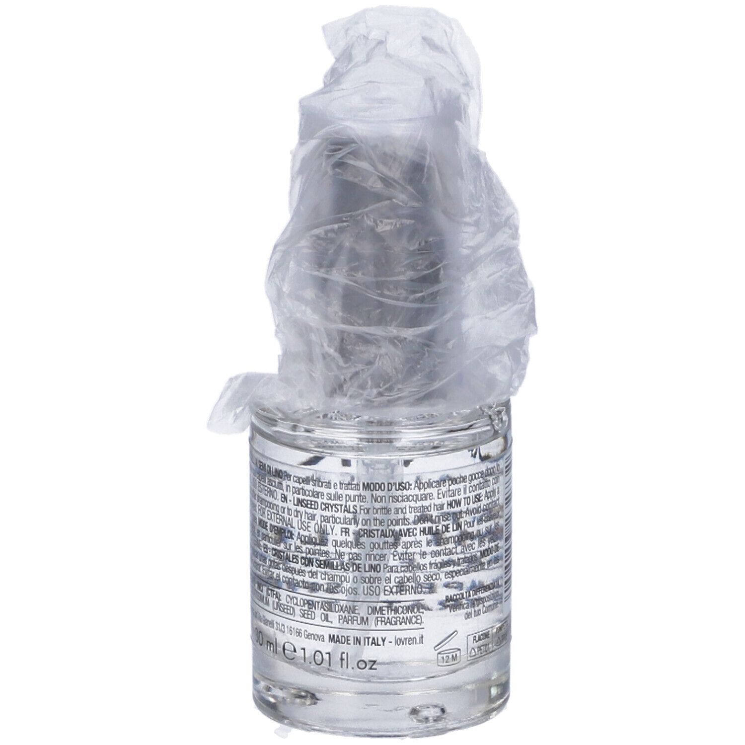 Flacone di vetro con liquido, parzialmente coperto da pellicola. Testo sul retro, tra cui 1.01 fl.oz.
