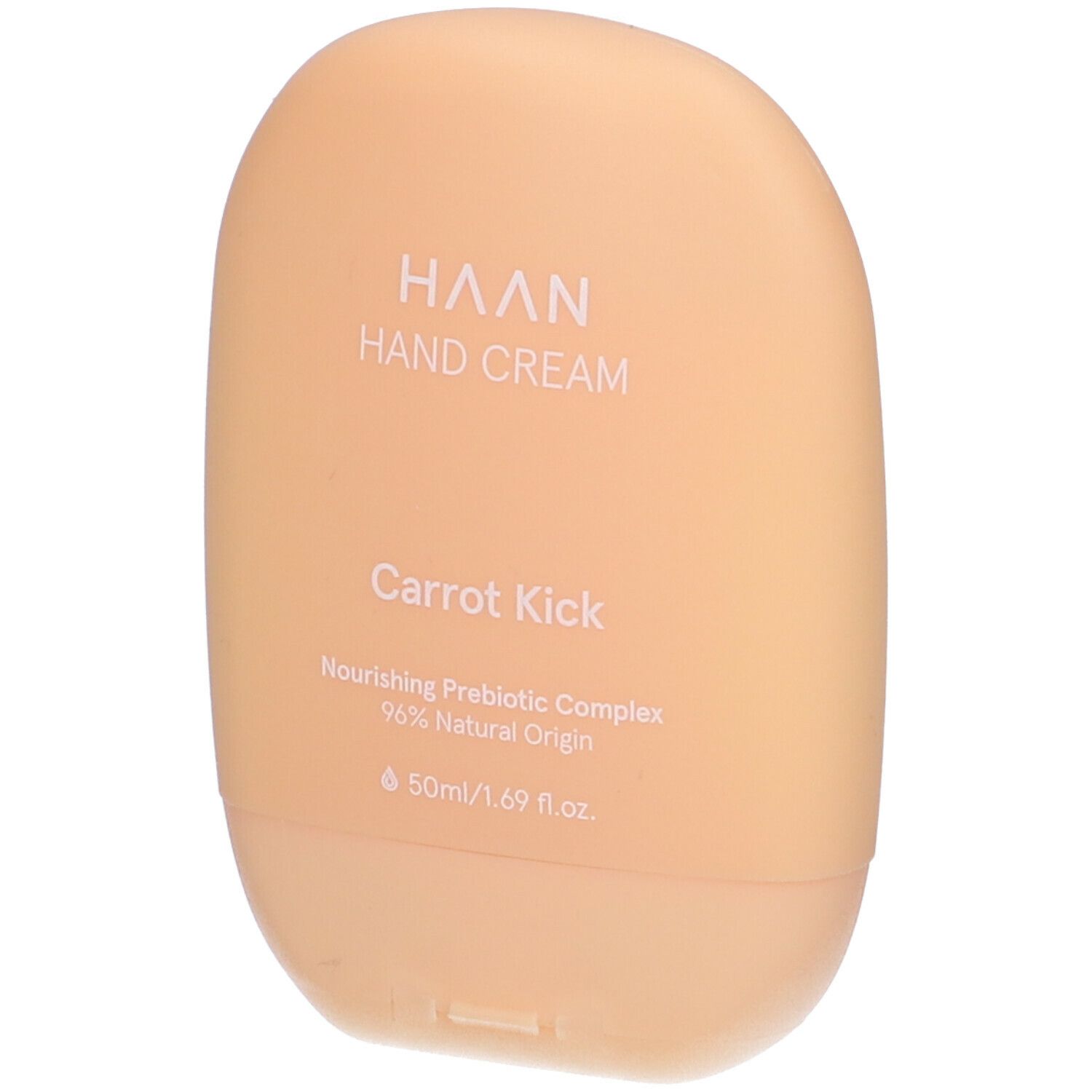 Tubo di crema mani beige. Scritta: HAAN, Hand Cream, Carrot Kick. Contiene il 96% di ingredienti naturali.