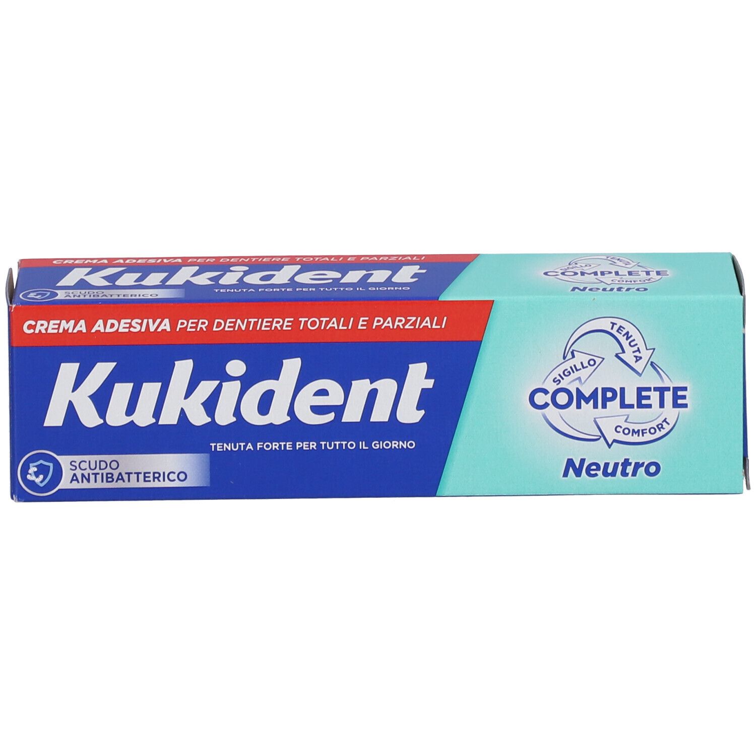Scatola di Kukident Complete Neutro. Scritta blu, sfondo rosso e verde. Protezione antibatterica.