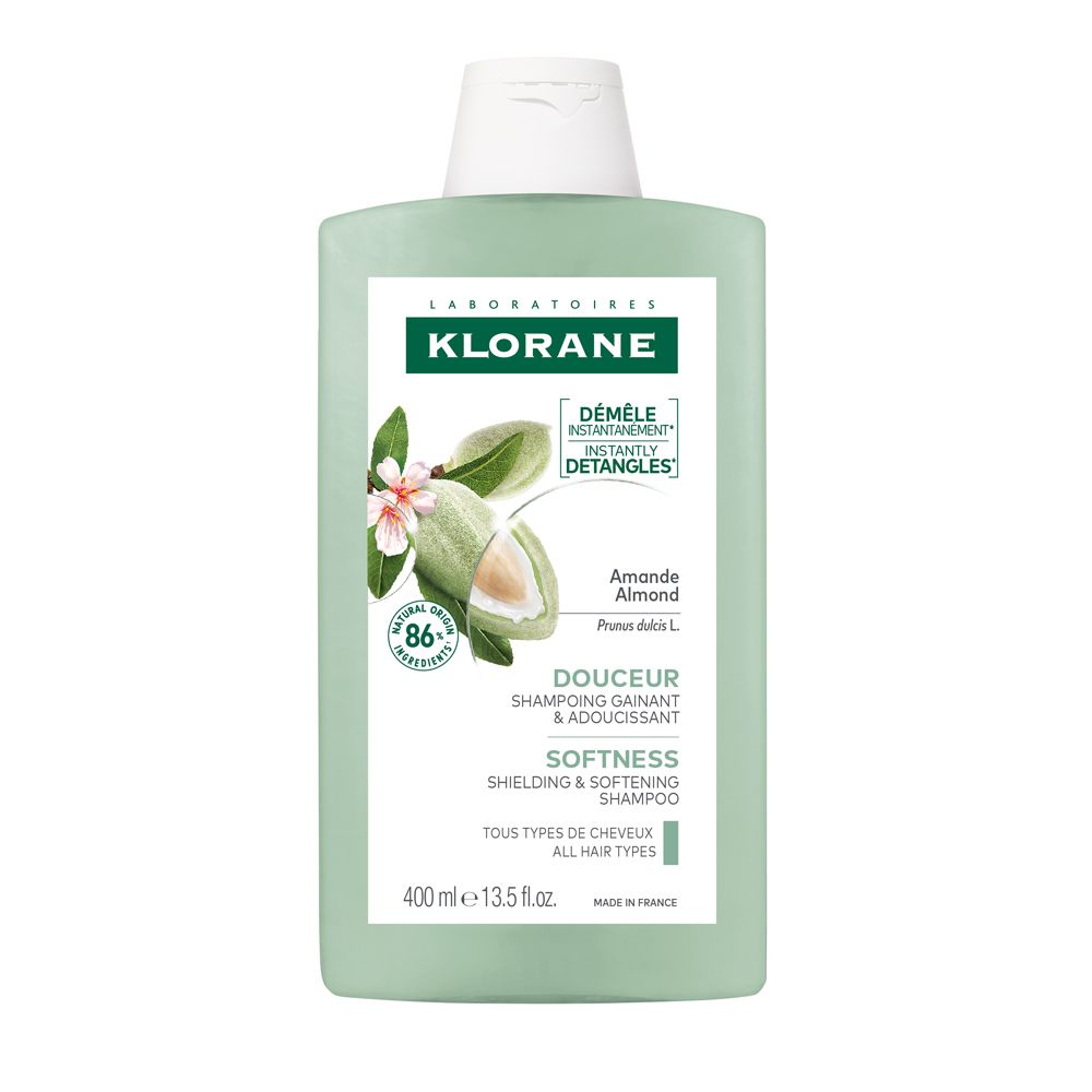 Bottiglia di shampoo verde con tappo bianco. Scritta Klorane, Mandorla, Douceur, Shampooing. Contiene un'illustrazione di mandorle.