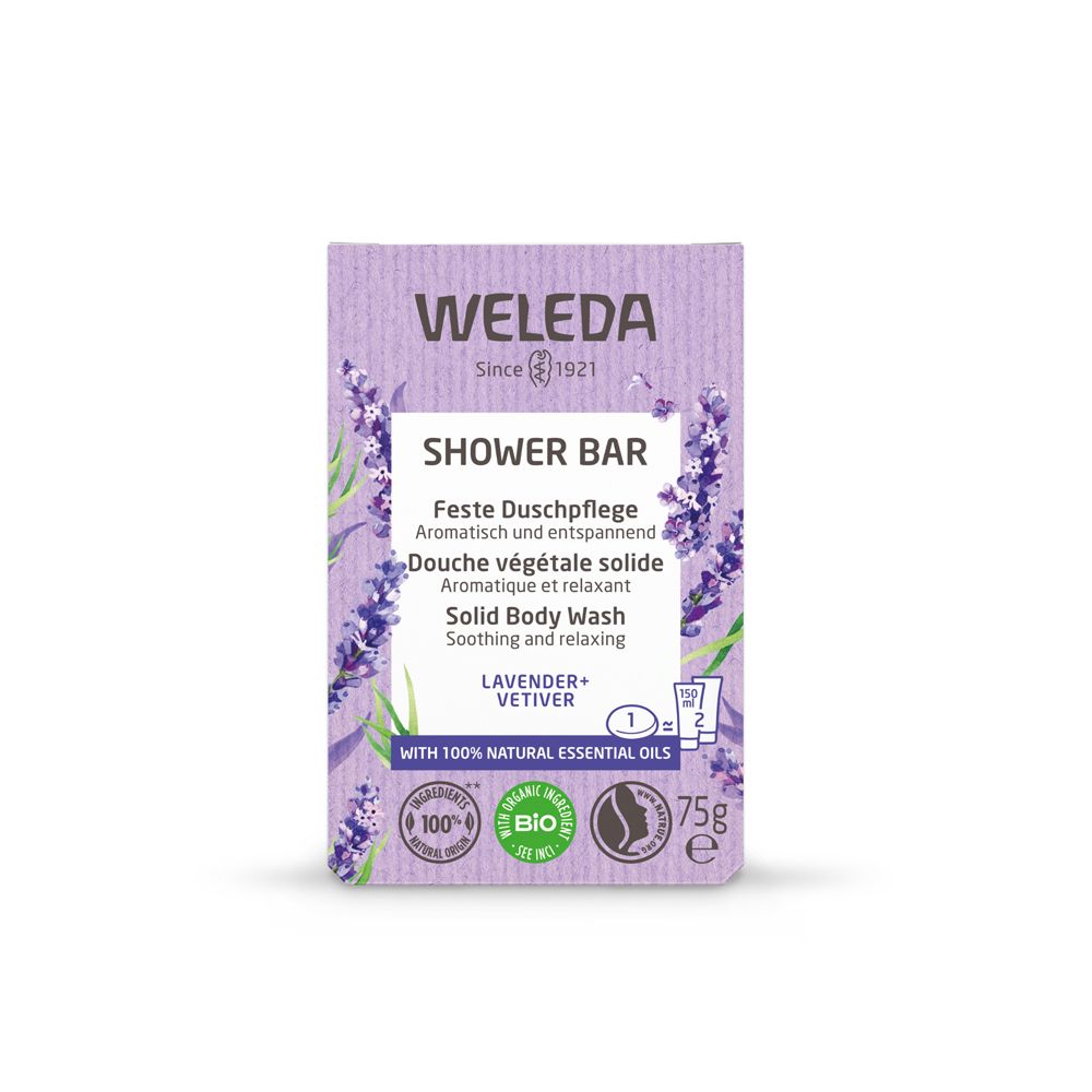 Scatola viola con "WELEDA" e "SHOWER BAR". Testo in tedesco, francese e inglese. Logo lavanda e vetiver.