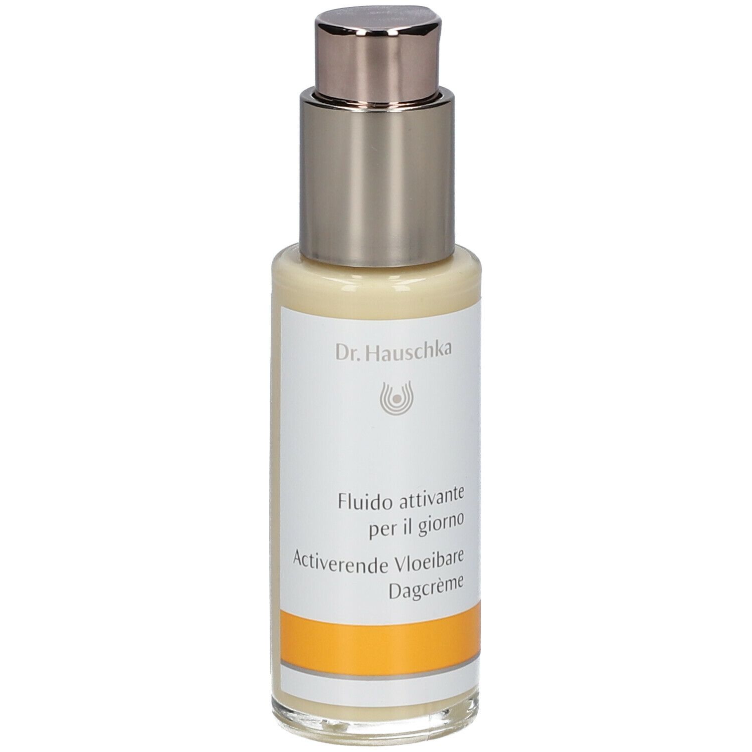 Flacone beige con erogatore argentato. Scritta: Dr. Hauschka, Fluido attivante per il giorno, Activerende Vloeibare Dagcrème.