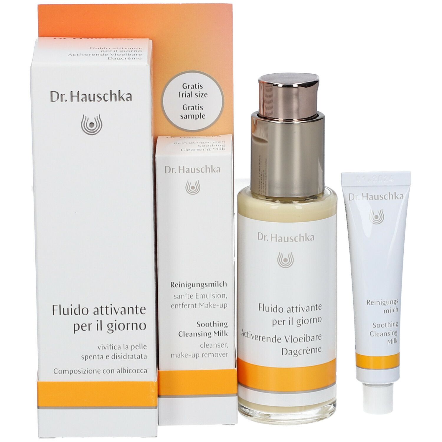 Set di prodotti con flacone, tubo e confezioni. Scritta: Dr. Hauschka, Fluido attivante per il giorno, Soothing Cleansing Milk.