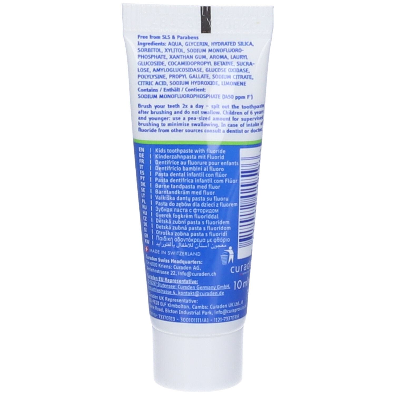 Retro del tubetto di dentifricio. Scritta blu su sfondo bianco. Contiene ingredienti e istruzioni per l'uso.